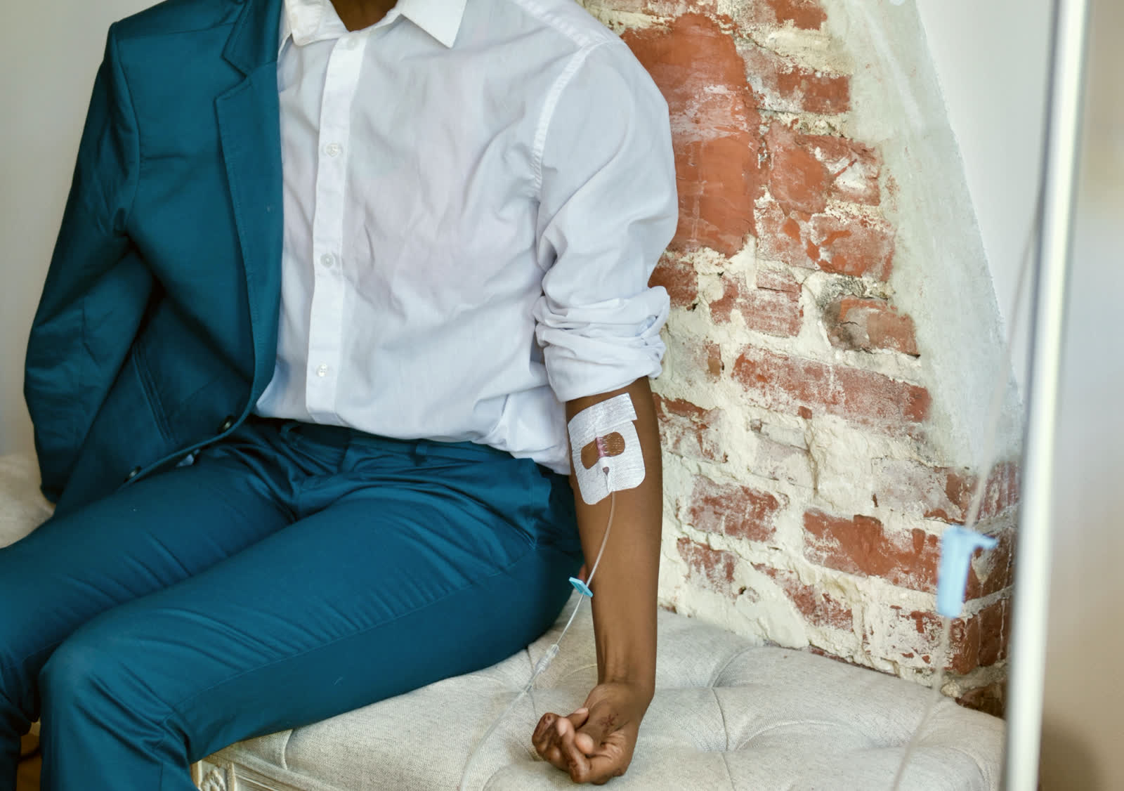 A client resting with an infusion running, photographed in daylight