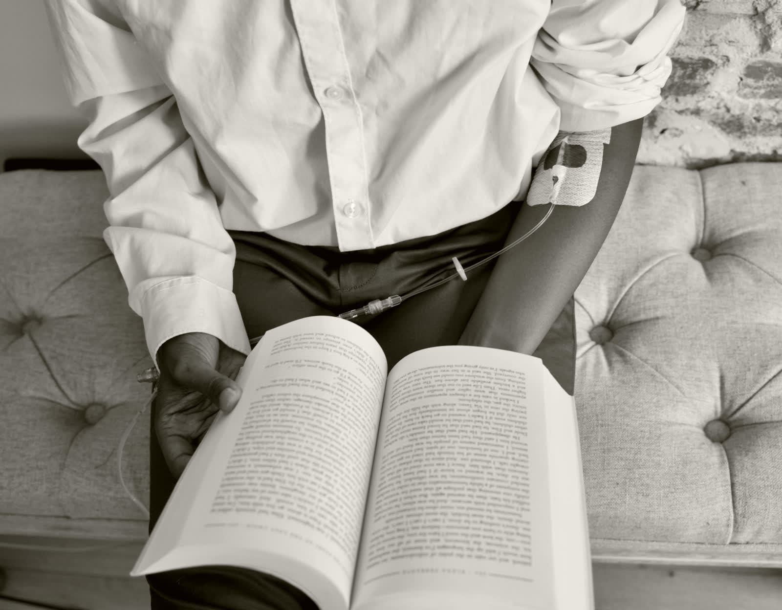 A client reading quietly while an infusion runs